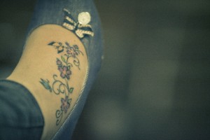 Feminine butterfly and flowers on foot tattoos