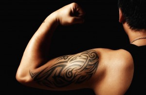 tribal arm tattoo on man