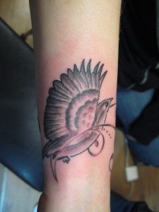 Black and Grey Swirly Bird Wrist Tattoo