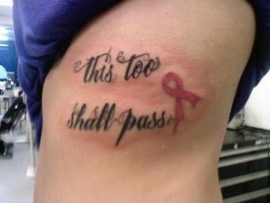 Inscription and pink ribbon tattoo