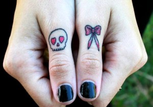 Skull and Bow Thumb Knuckle Tattoo