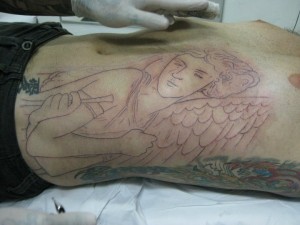 angel tattoo on the side of the stomach