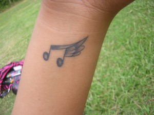 Music note with wings tattoo Music note with wings tattoo