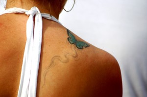 Tiny butterfly body art on shoulder