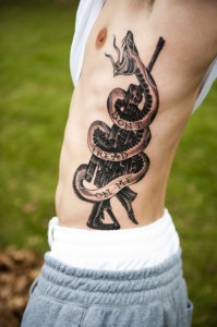 Rifle and Snake Ribcage Tattoo