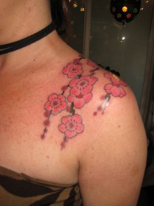 Shoulder Draped Hawaiian Flowers Tattoos