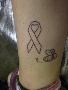 Ribbon, heart and bee tattoo