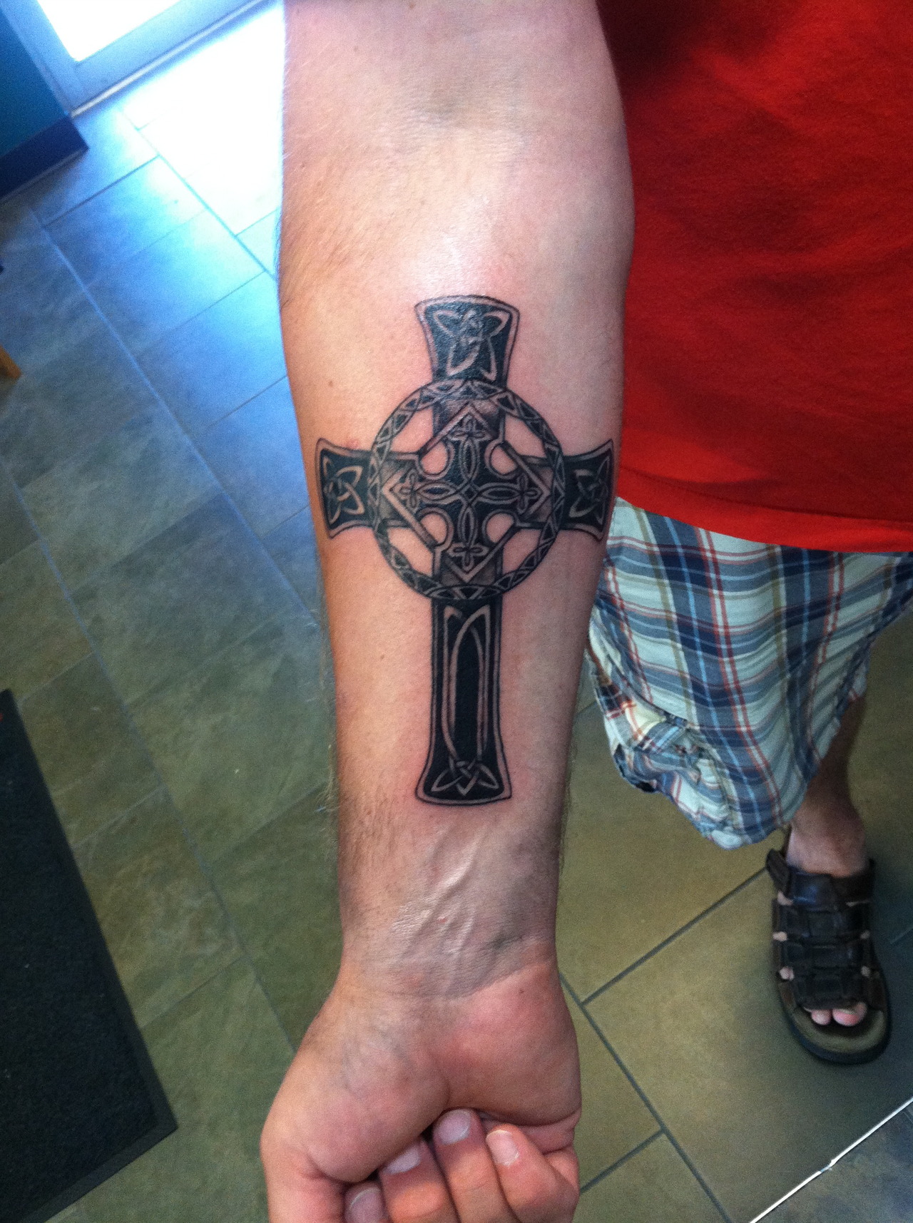 Wooden Cross In Hand Tattoo On Half Sleeve