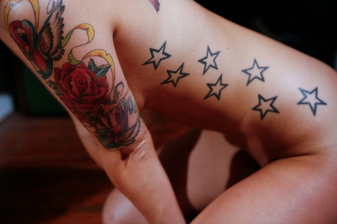 stars tattoo on rib cage and waist