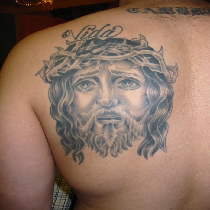 jesus tattoo on shoulder blade