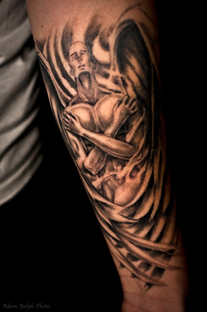 angel tattoo on forearm