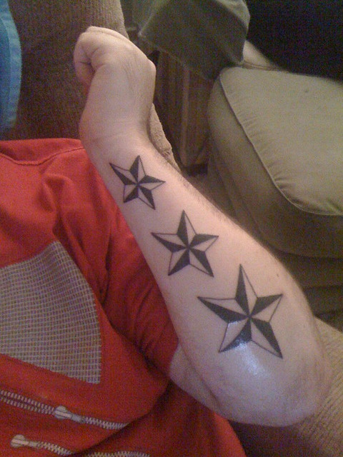 stars tattoo on forearm