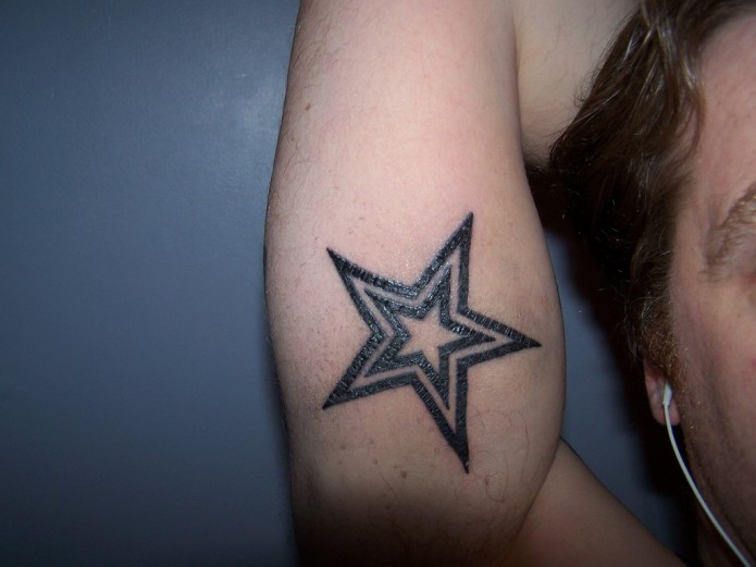 star tatoo on forearm