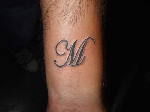 Letter M tattoo on the hand
