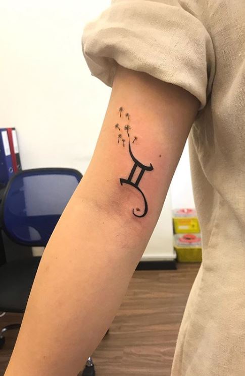 Minimalistic Gemini zodiac symbol tattoo located on the