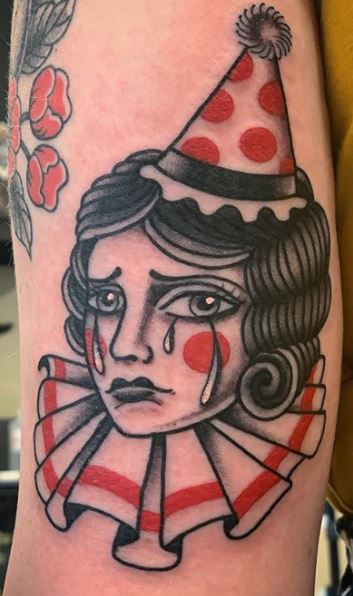 Kewpie clown tattoo located on the upper arm