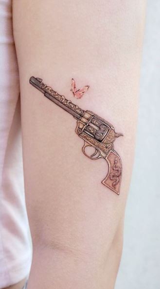 Arm Realistic Women Gun Tattoo by Piranha Tattoo Studio