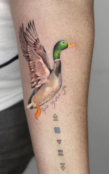 Rubber duck and boat tattoo on the calf