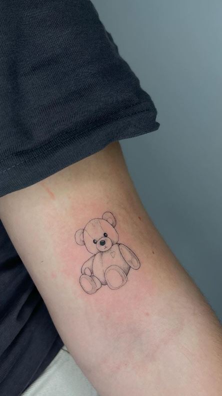 teddy bear tattoo done on the bicep