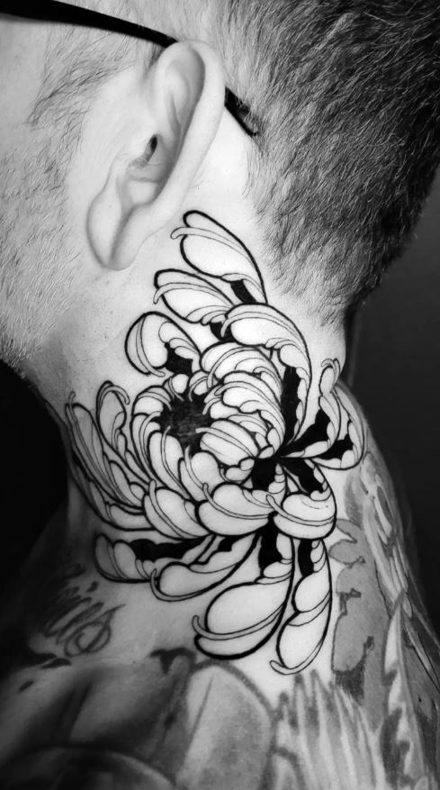 Chrysanthemum tattoo on the left inner wrist.